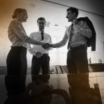 businesspeople-shaking-hands-workplace